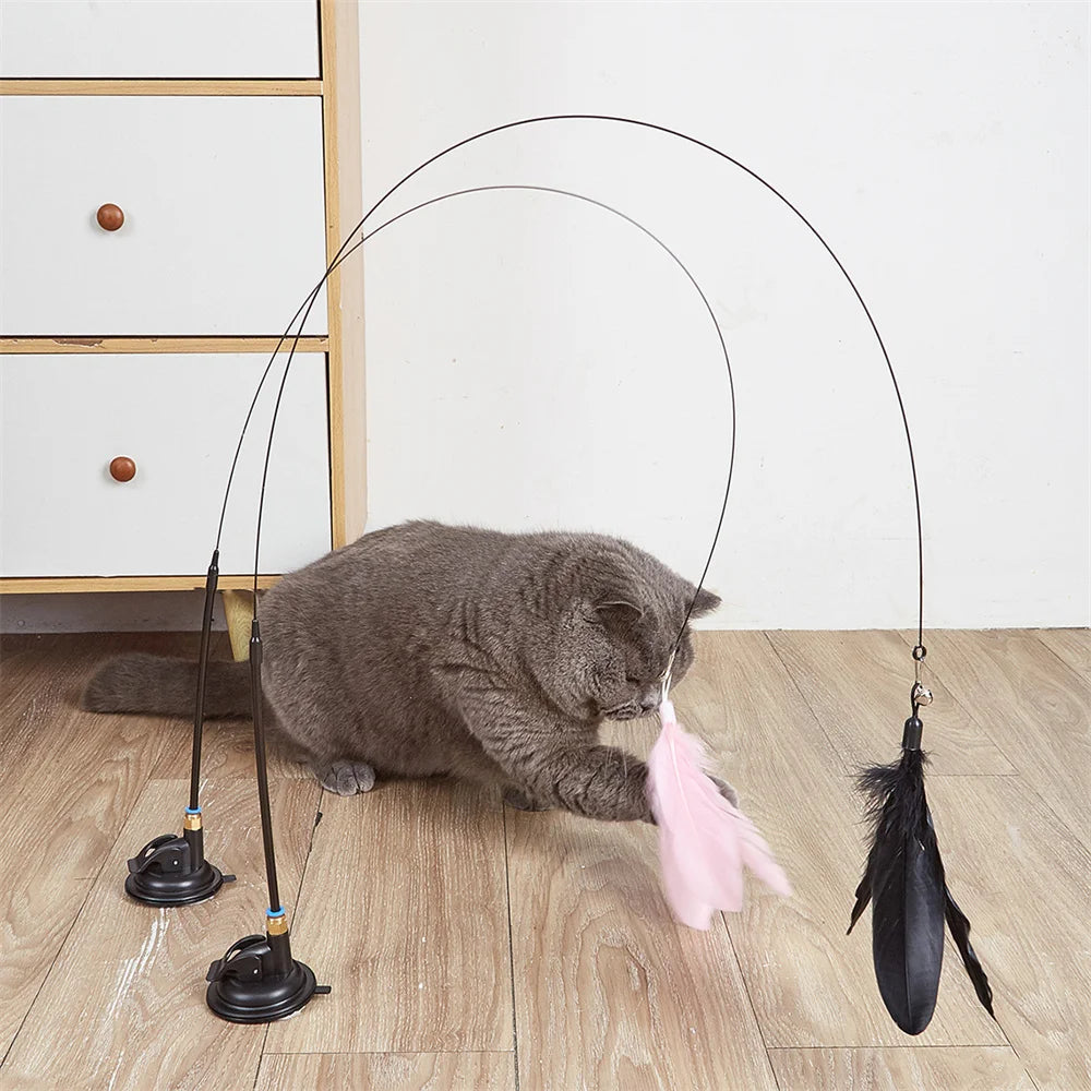 Interactive cat teaser toy with feathers, bell, and suction cup